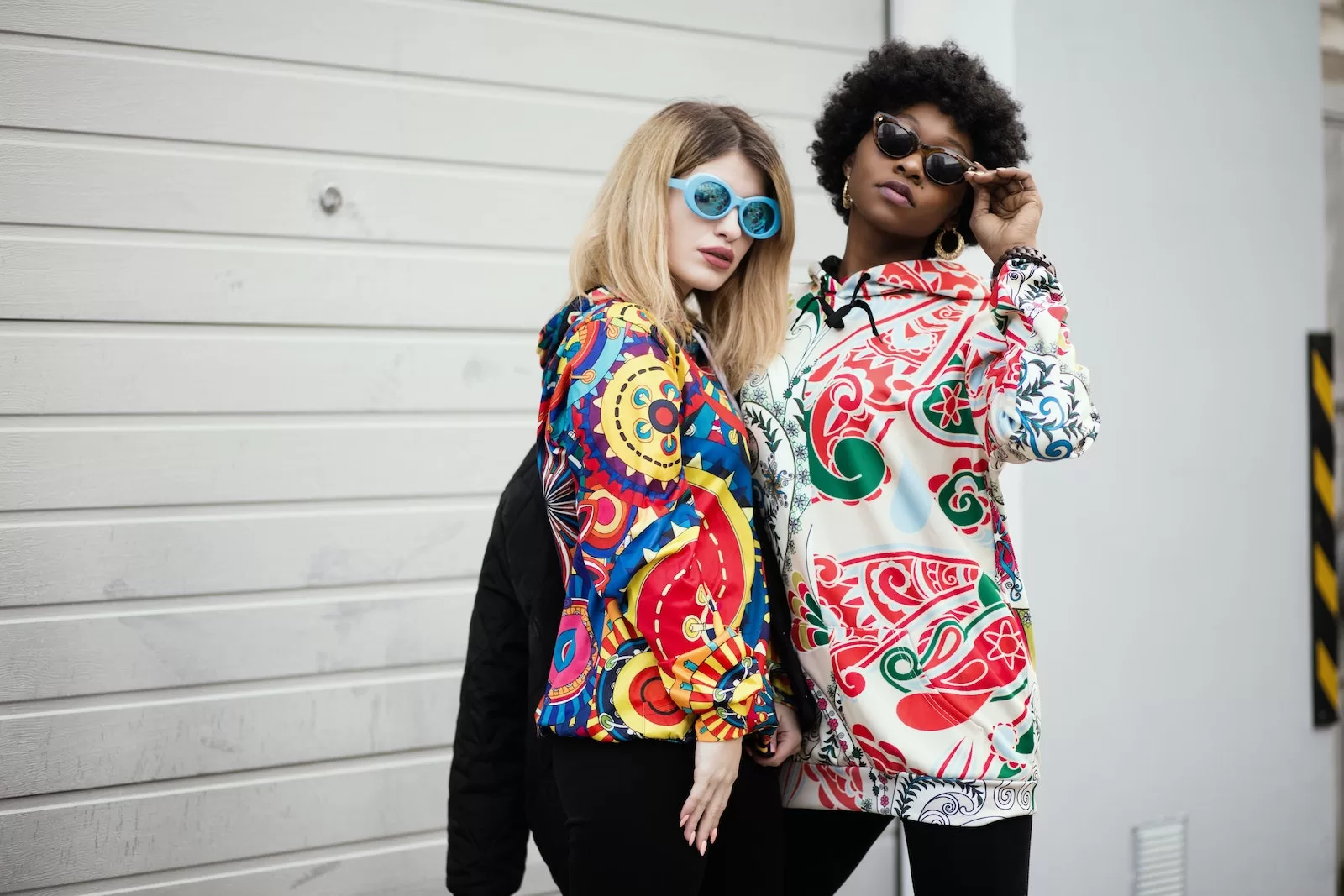 Bohita | Two Women Standing Near Roller Shutter